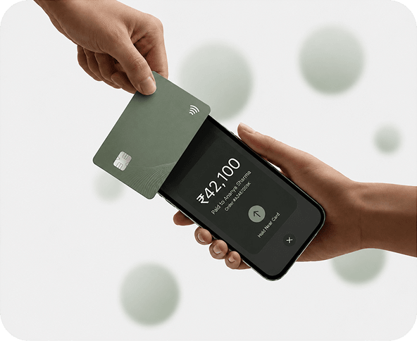 Hand holding a payment card near a phone